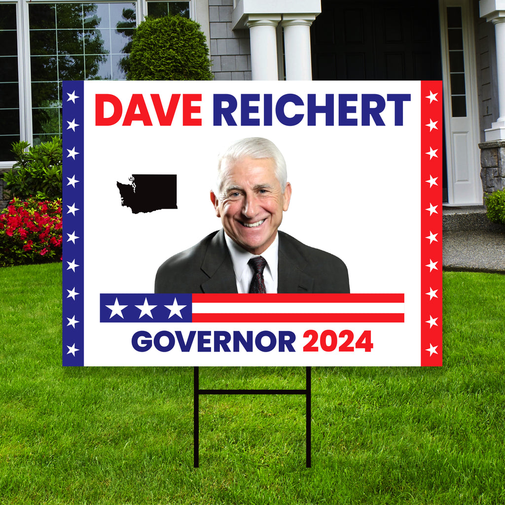 a political yard sign in front of a house