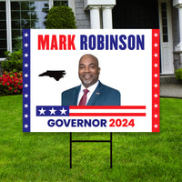 a political yard sign with a picture of a man in a suit