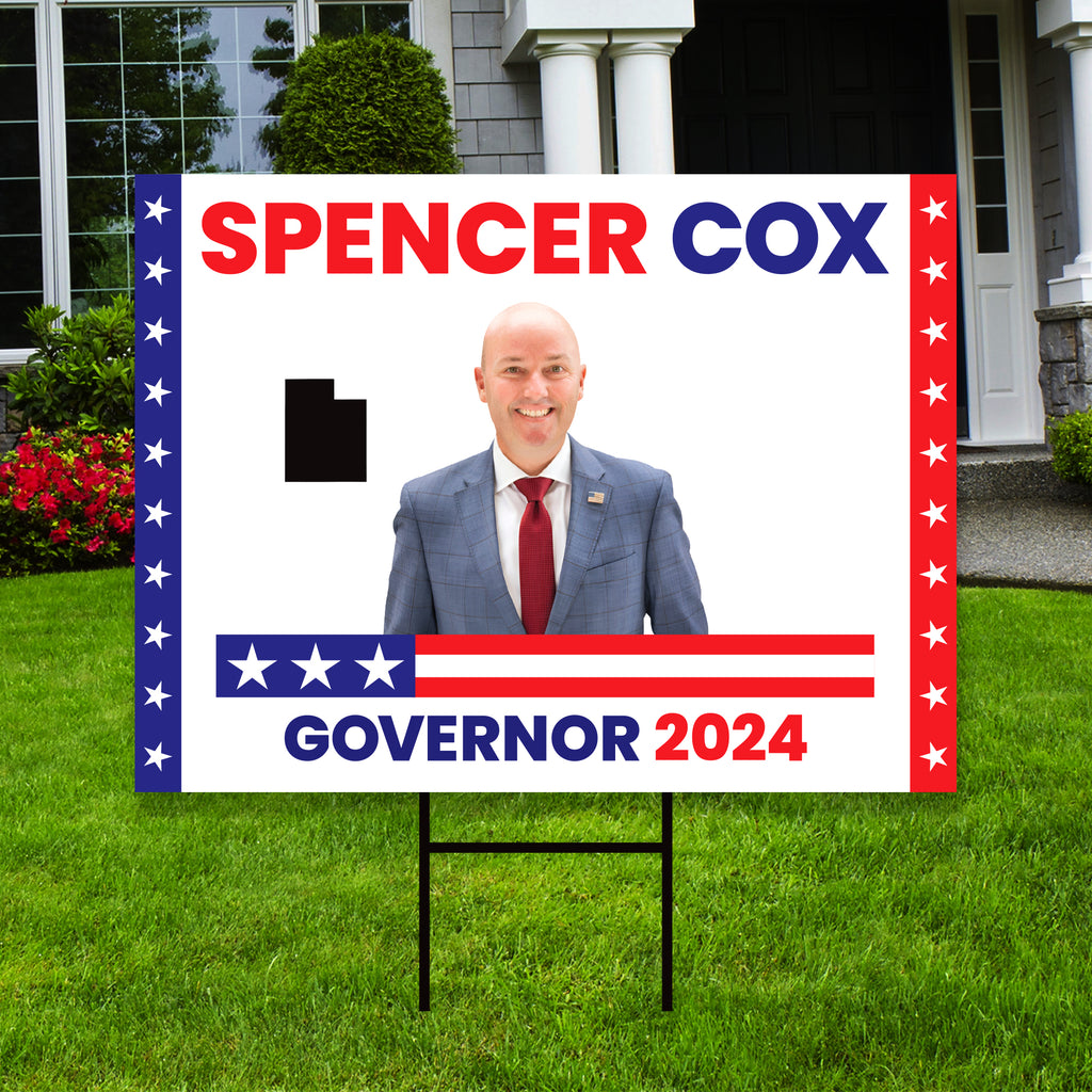 a political yard sign with a picture of a man in a suit